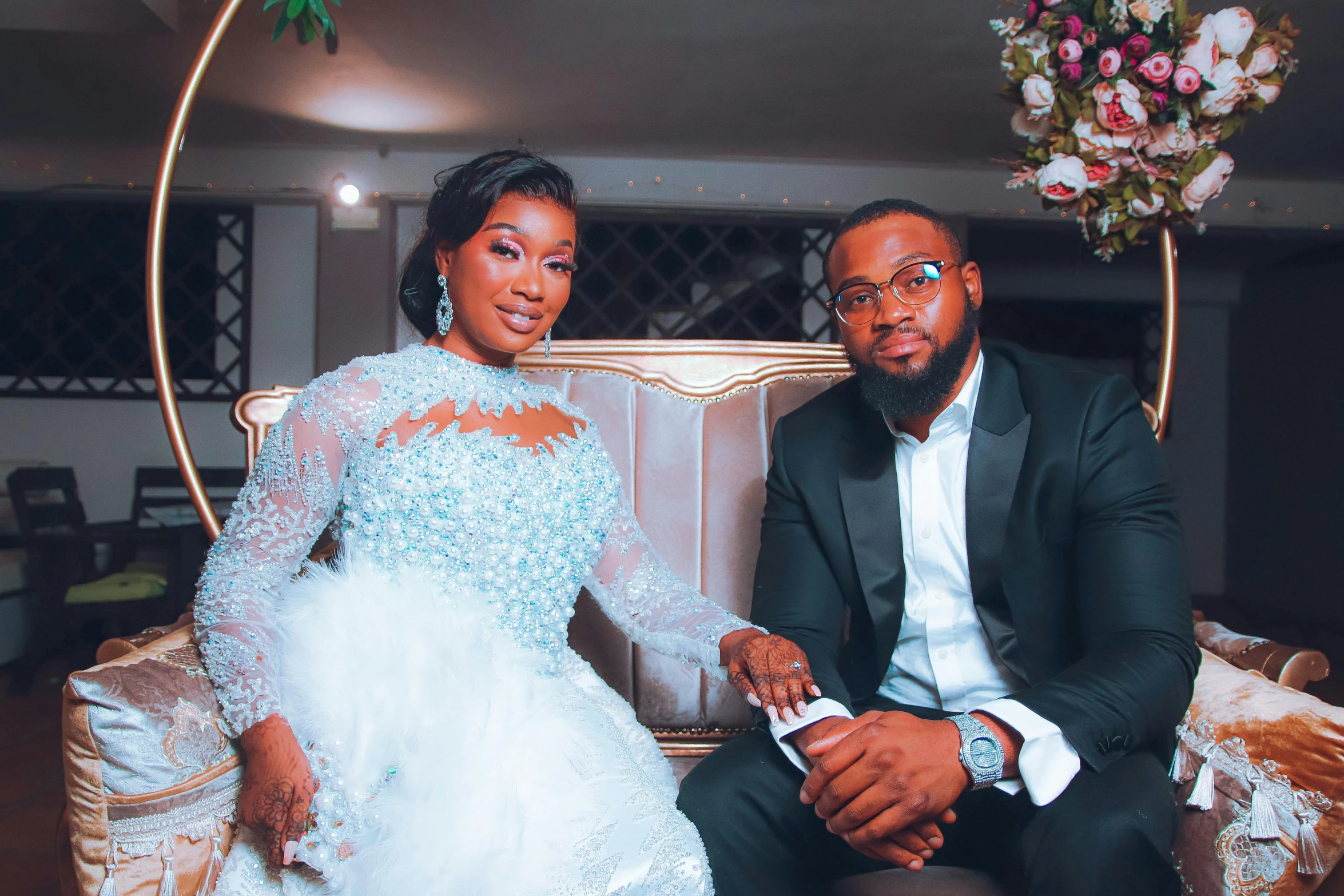 man and woman wearing formal wear sitting on a couch