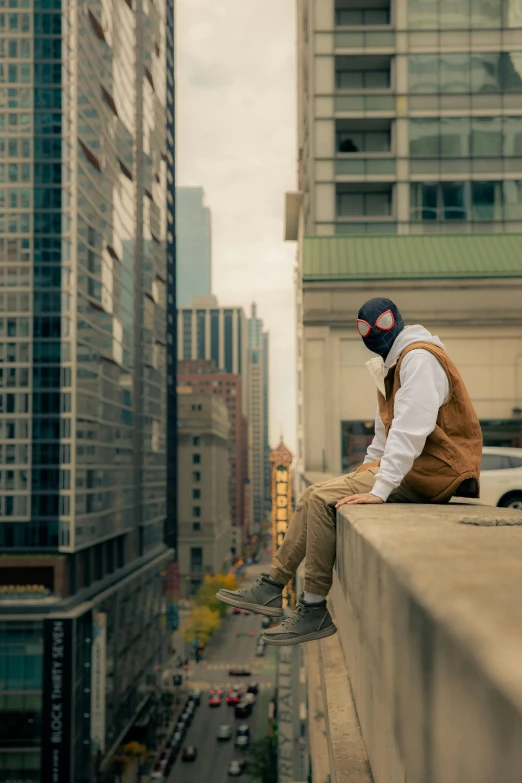 a person that is sitting on a ledge