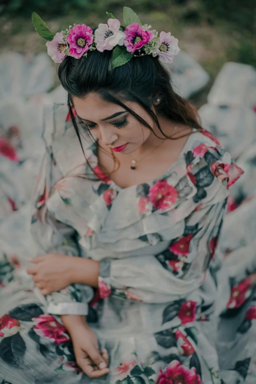 a woman is dressed in an open flowered dress