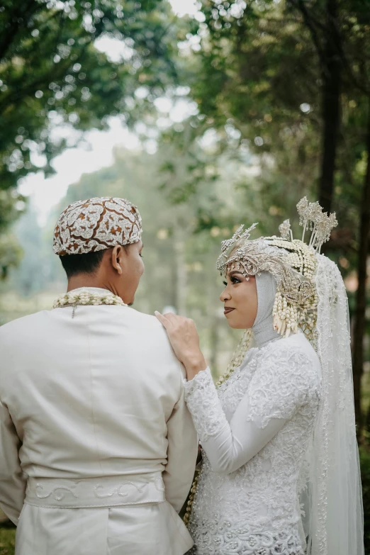 a man and woman dressed in wedding attire