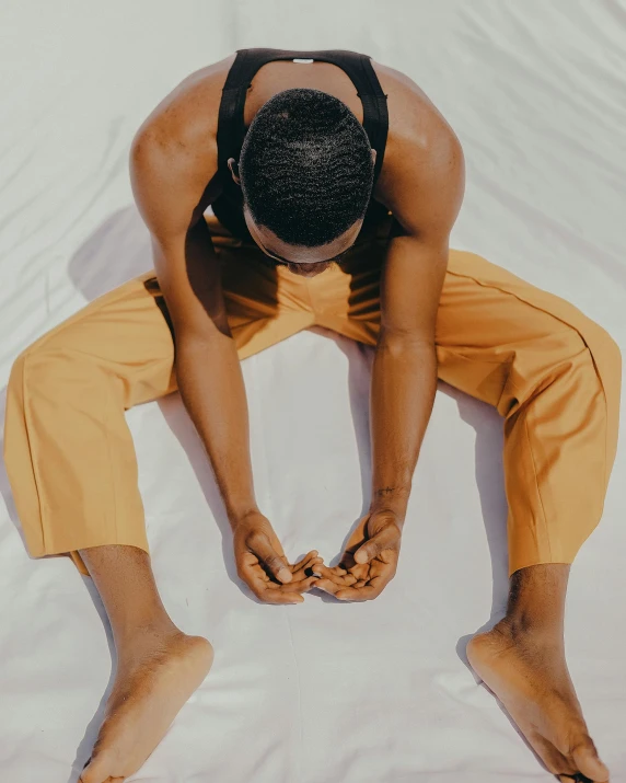 a person is doing a yoga pose on the bed