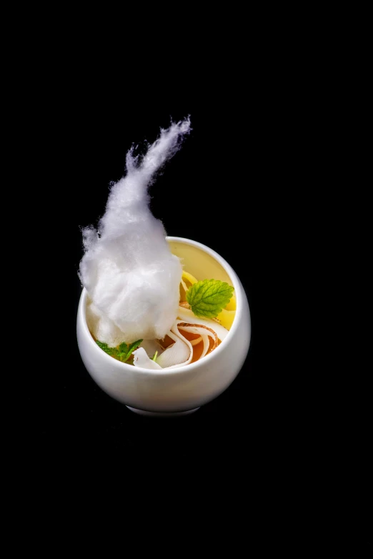 white cotton being thrown into a small bowl