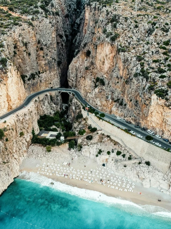 a long winding mountain road curves towards the ocean