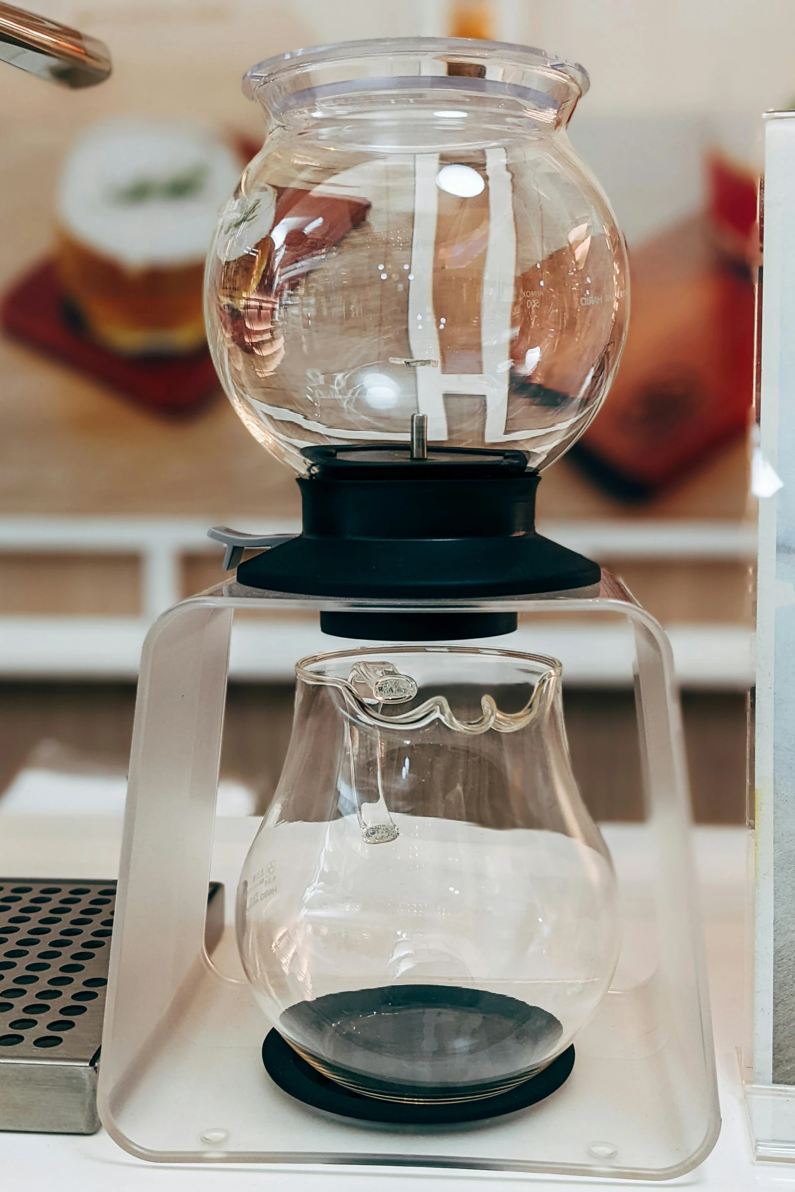 a glass teapot on top of a clear cup