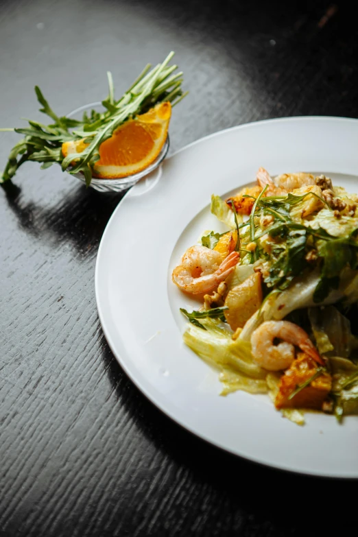 a plate of food and a small glass