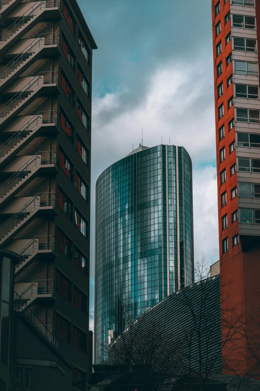 a tall red building sitting next to other tall buildings