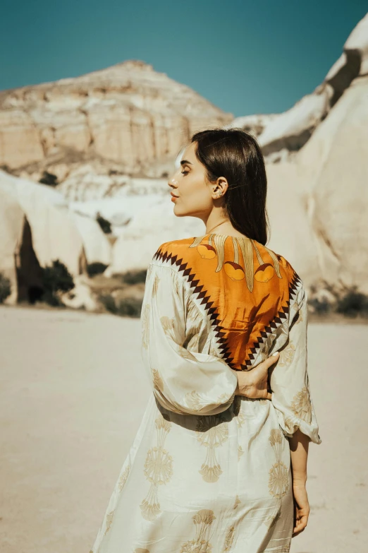 a woman with a dress on in the desert