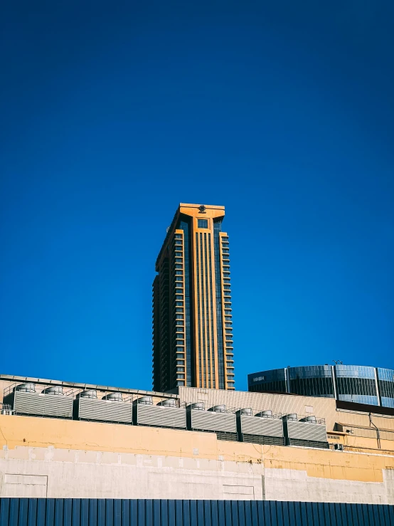 a very tall building in the middle of a blue sky