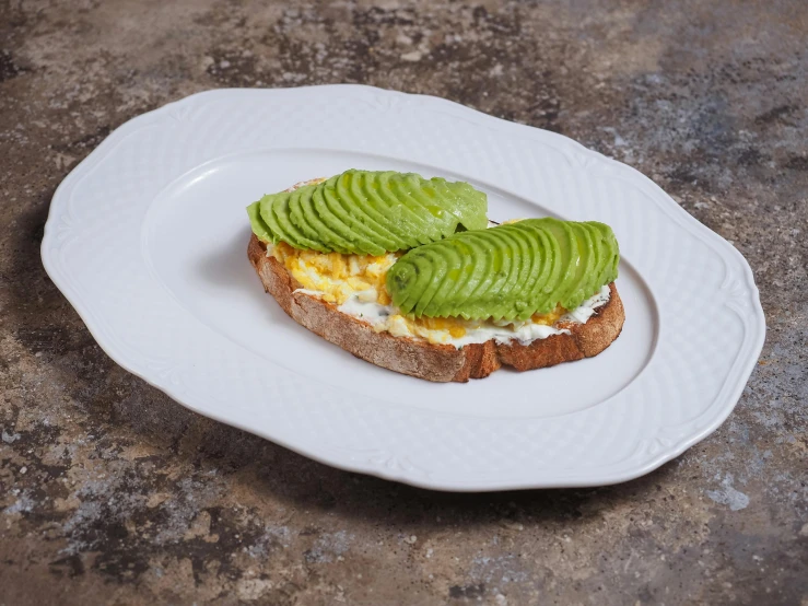 a piece of bread topped with green fruit
