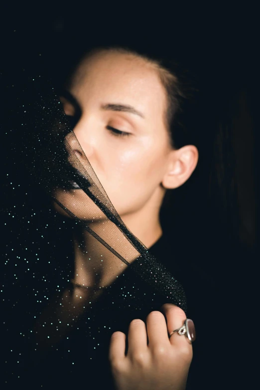 the young woman is wearing a veil around her neck