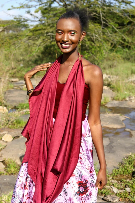 a woman is walking and smiling on a path