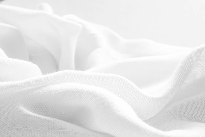 an image of white cloth on a bed