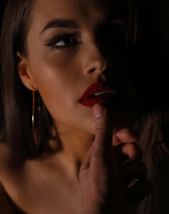 a woman with lipstick on a dark background