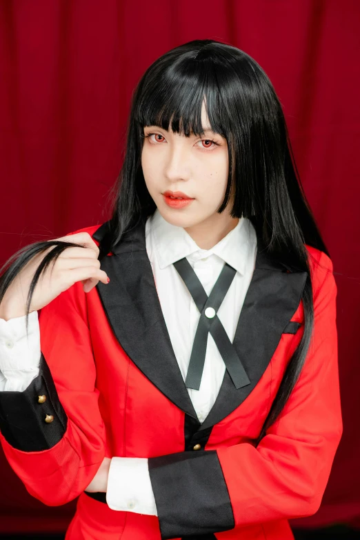 a woman wearing red, black and white clothes, standing in front of a red background