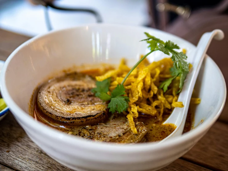 bowl of food with an open spoon next to it