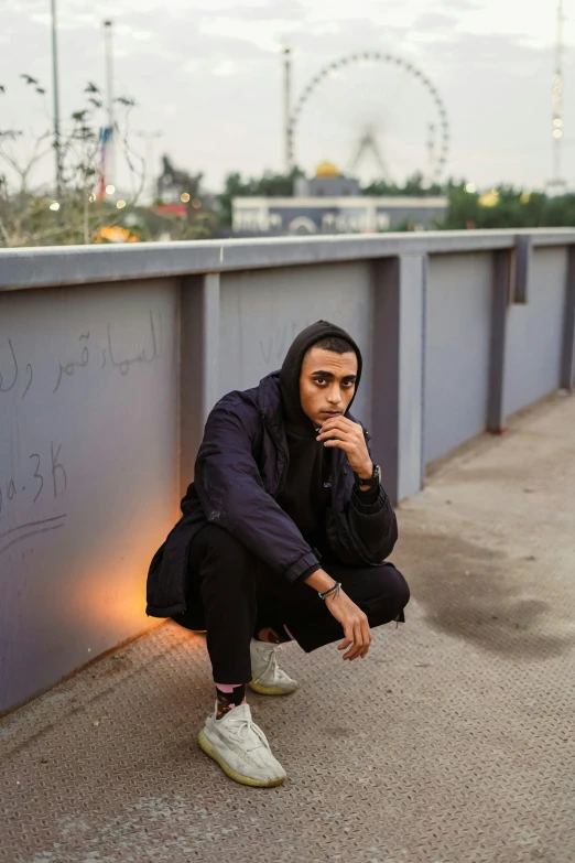 a man sitting on the edge of a walkway