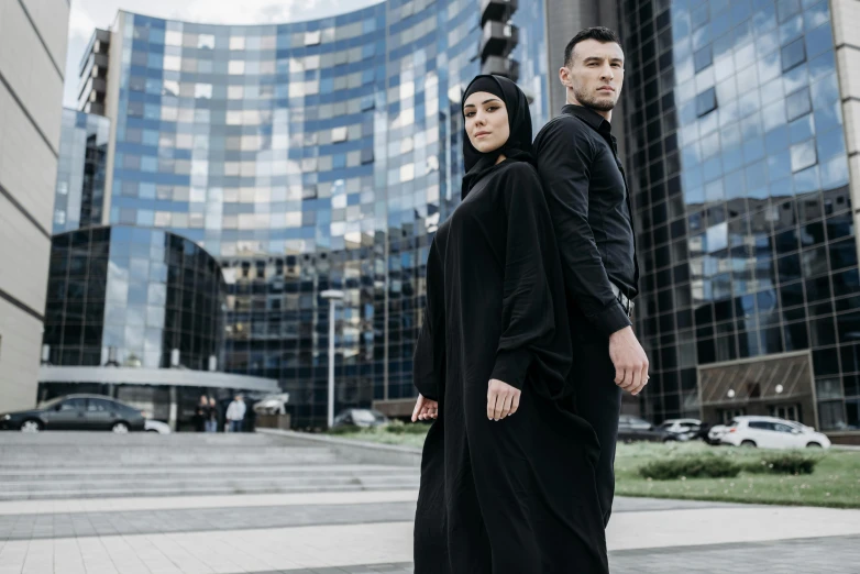 a man and a woman dressed in black outside