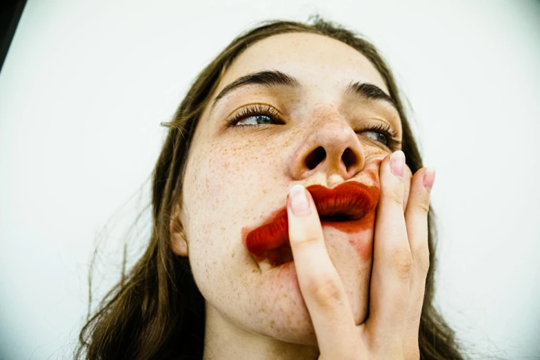 a woman making a fake bite into her lips