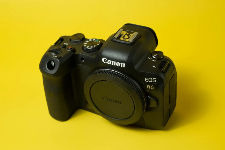 a digital camera on a yellow background