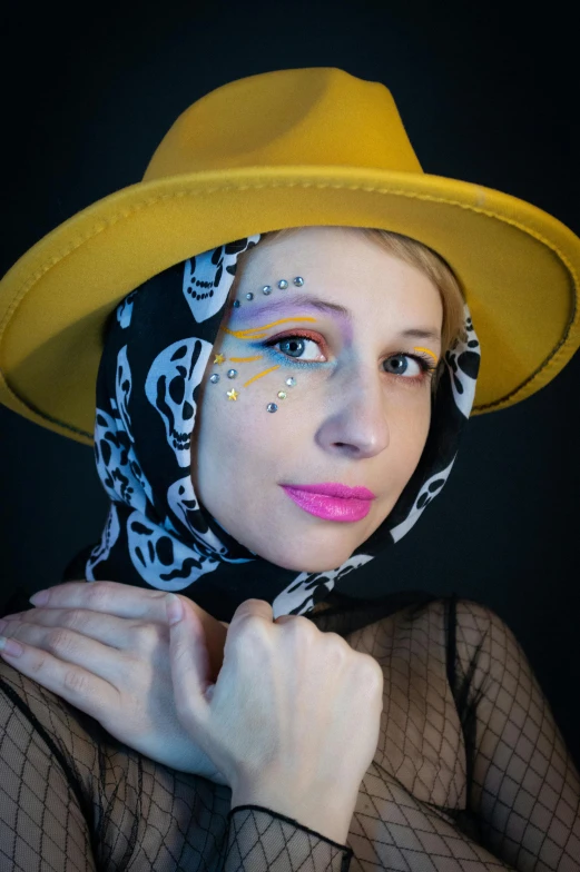 a woman wearing a yellow hat and some mesh