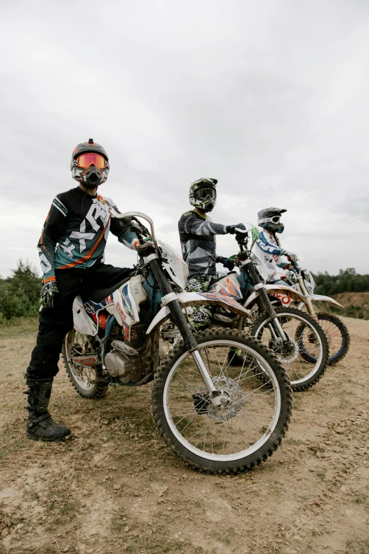 several motorcyclists all with helmets are posing for a po