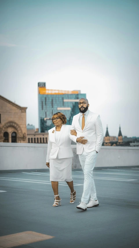 two men in white clothing standing near each other