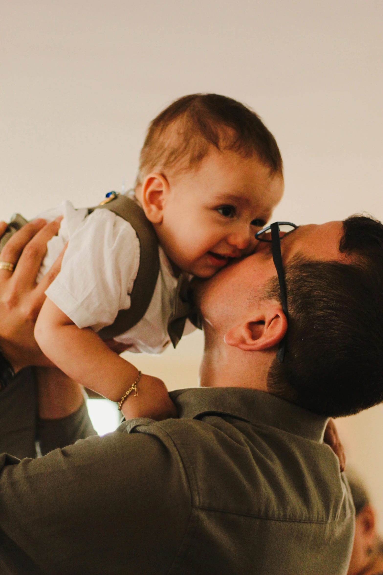 a man and his baby are playing with each other