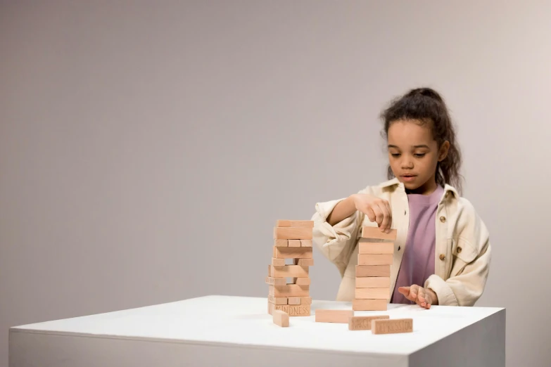 a  playing with blocks on a table