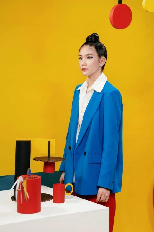 a woman standing in front of a display of fashion accessories