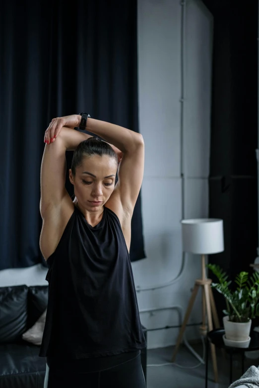 a girl sitting and stretching her back with one arm