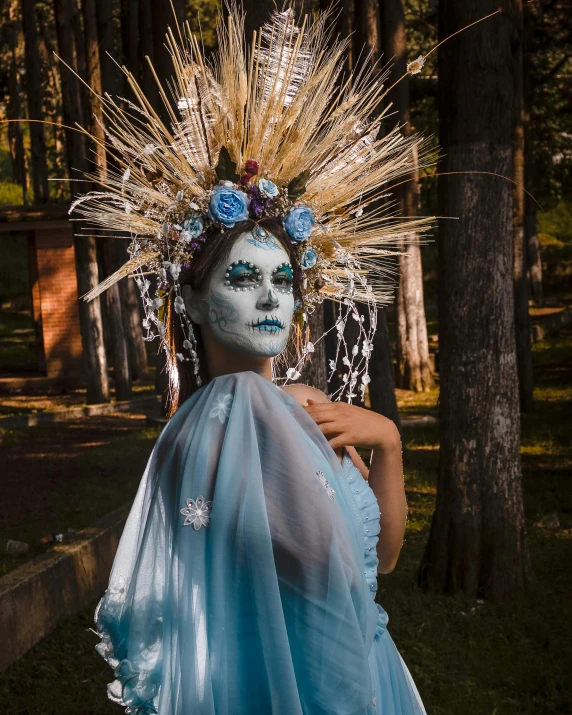 a woman in an elaborate dress with white face paint