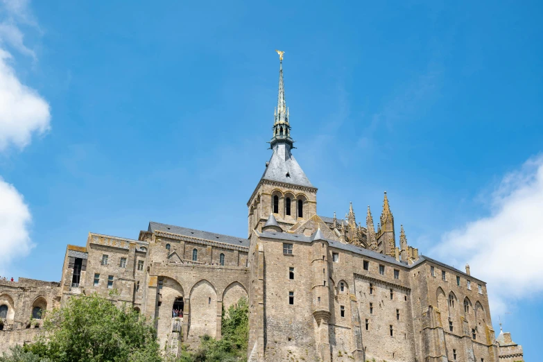 a cathedral like building with steeple under a clear blue sky