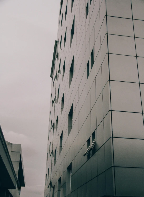 a tall white brick building next to another building