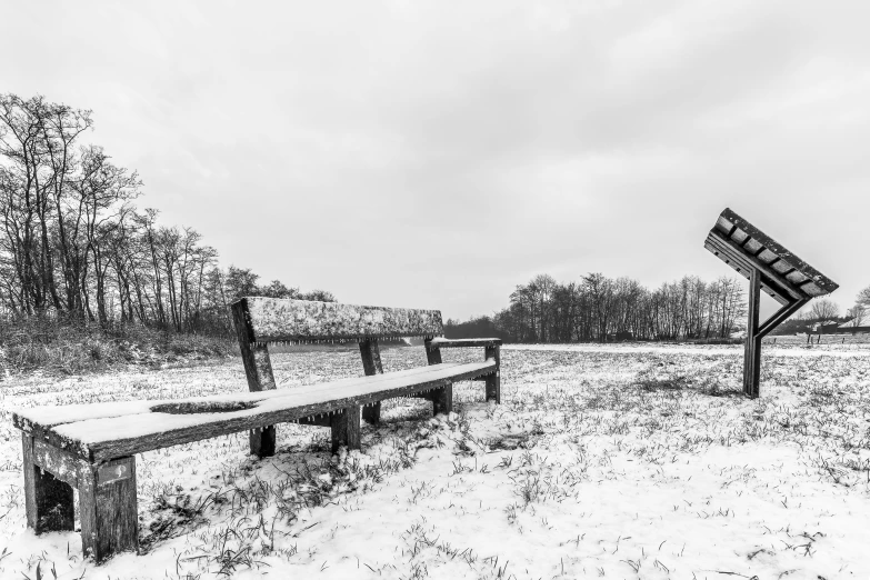 a black and white po of benches in snow