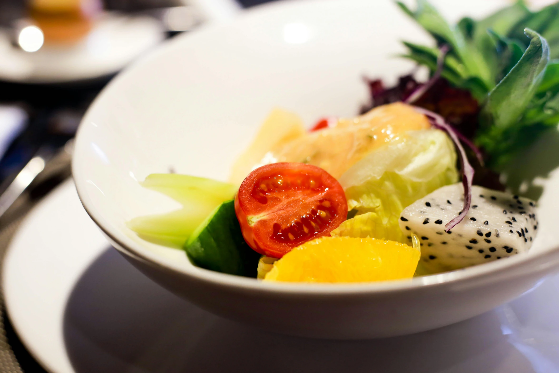 a dish on a white plate with cut fruit