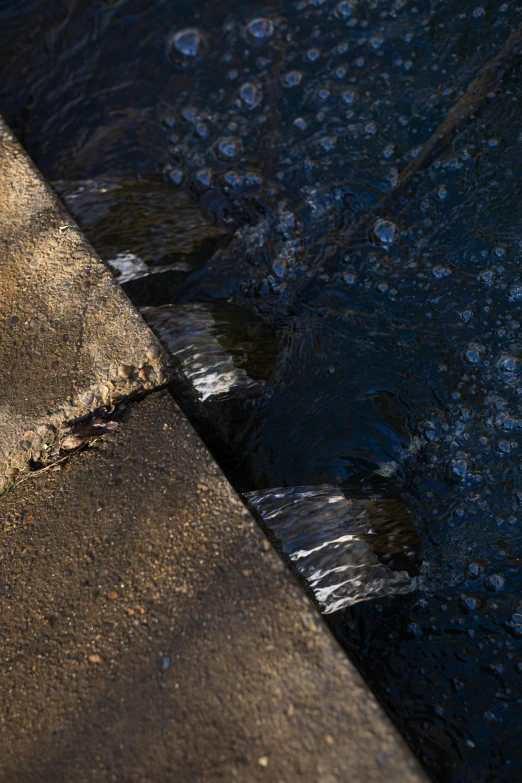 water streaming down the pavement into the street