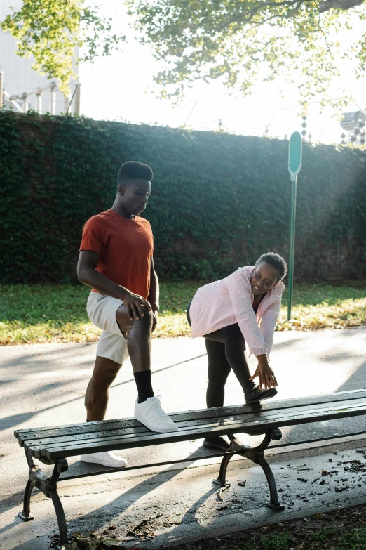 a couple plays tug rope in front of a park bench