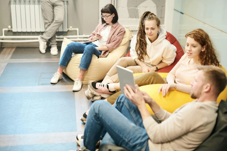 the group is sitting on bean bags together