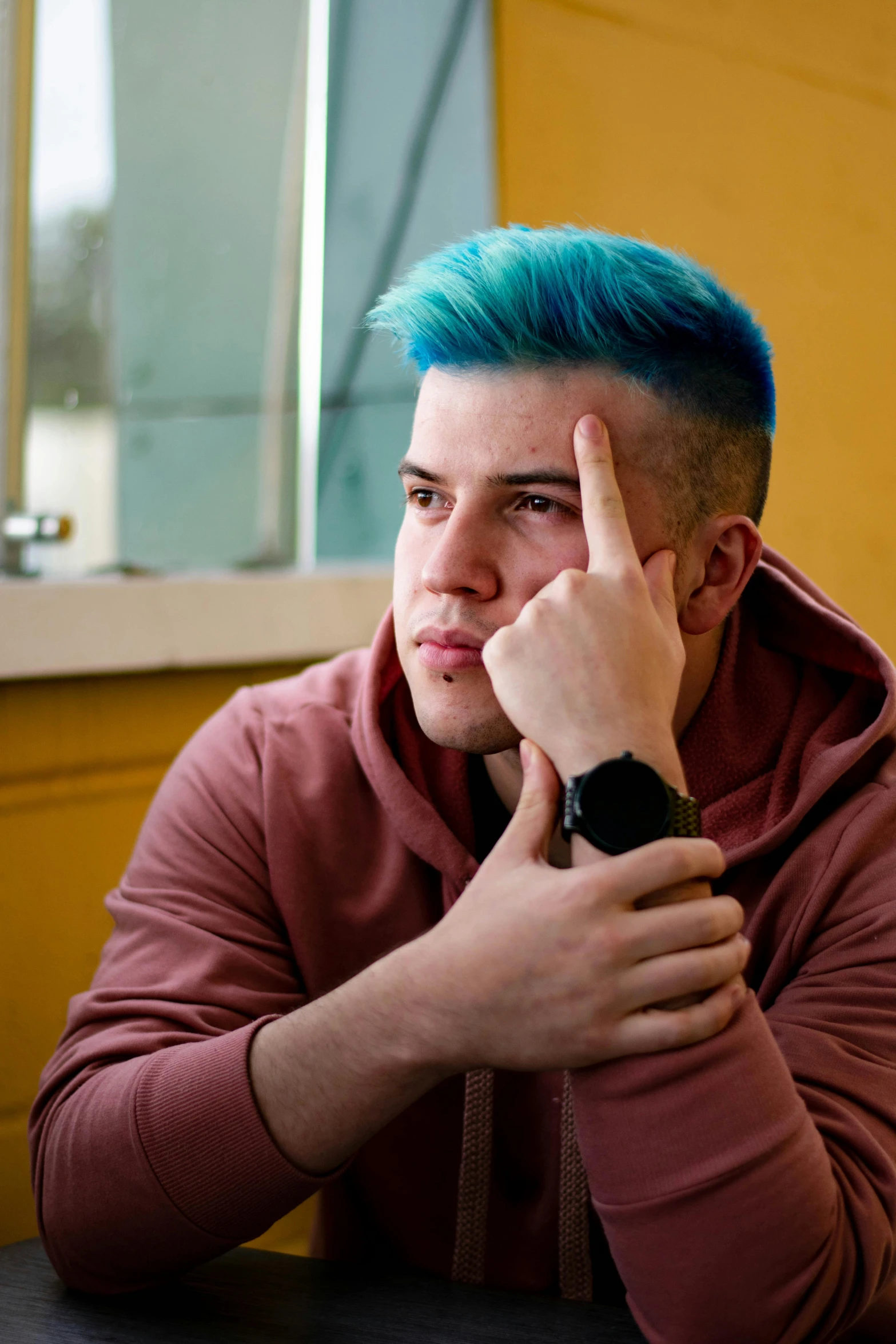 a man is making a hand gesture at a table