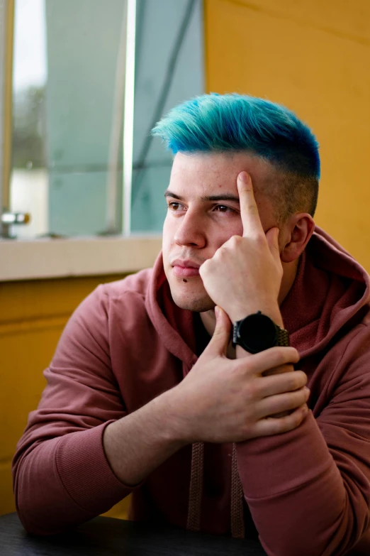 a man is making a hand gesture at a table