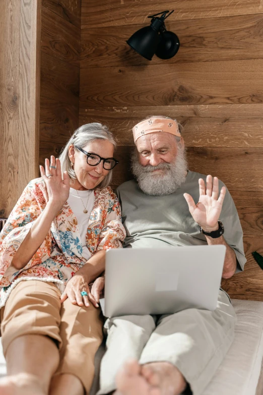 a man sitting next to a woman on top of a bed