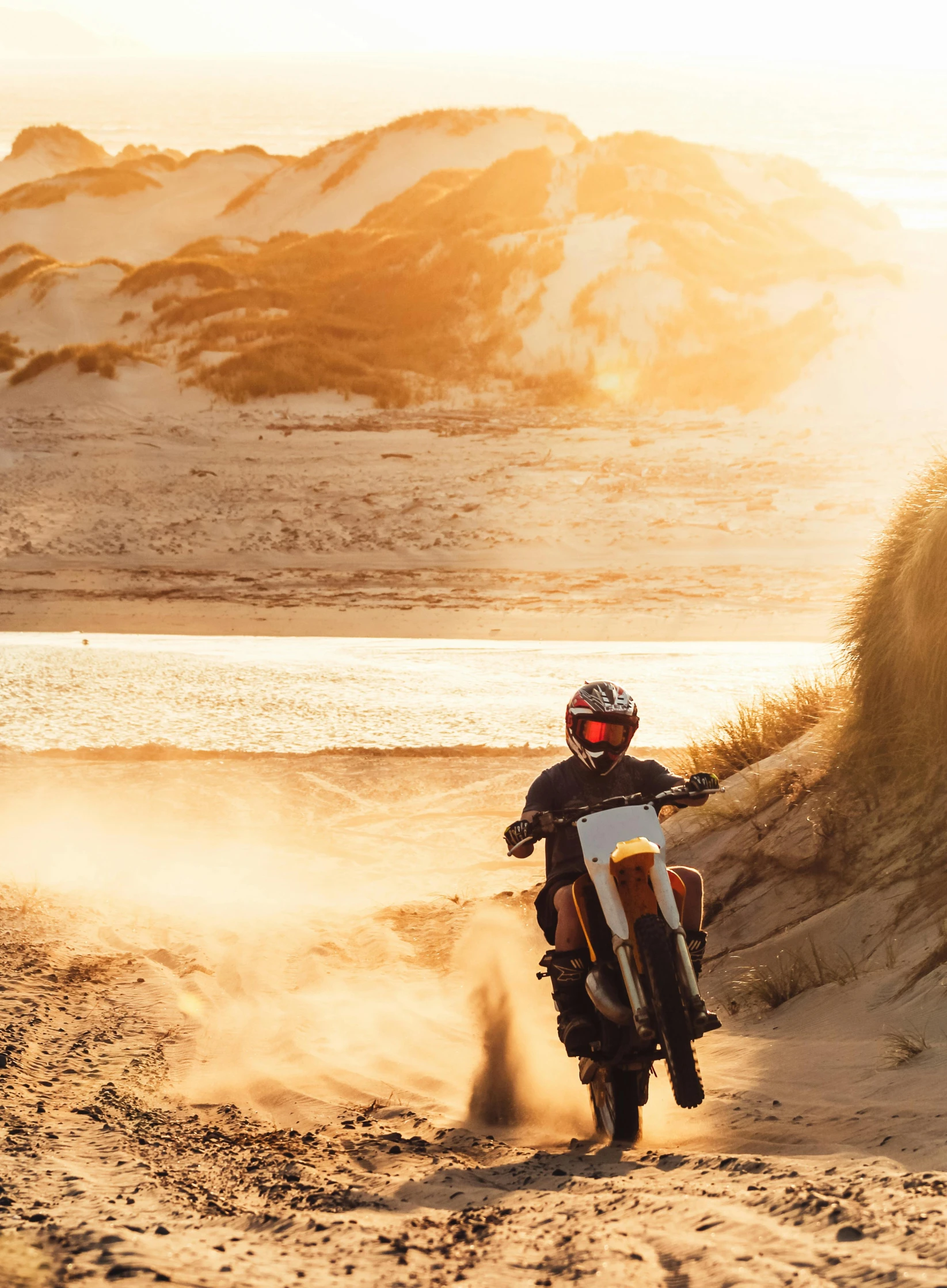 a man riding on the back of a white and black motorcycle