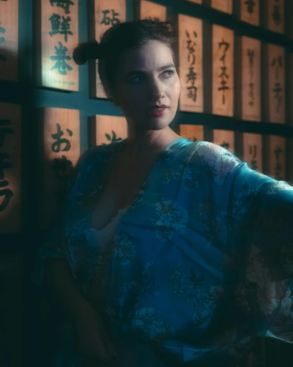 asian woman in blue and white robe standing by wall