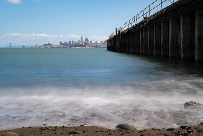 the ocean below a long pier near a city