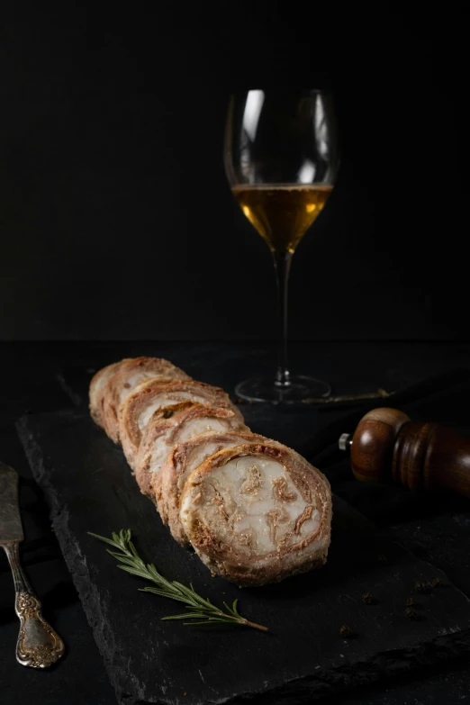 slices of bread and wine sitting on a table