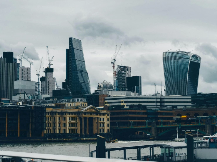 a city view from across a river with some tall buildings