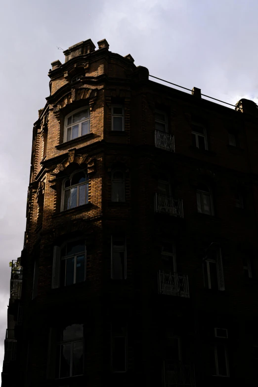 a tall brown brick building with a lot of windows