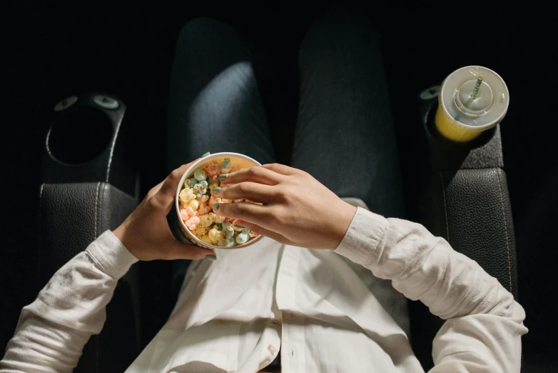 man in the seat of the bus enjoying a bowl of soup