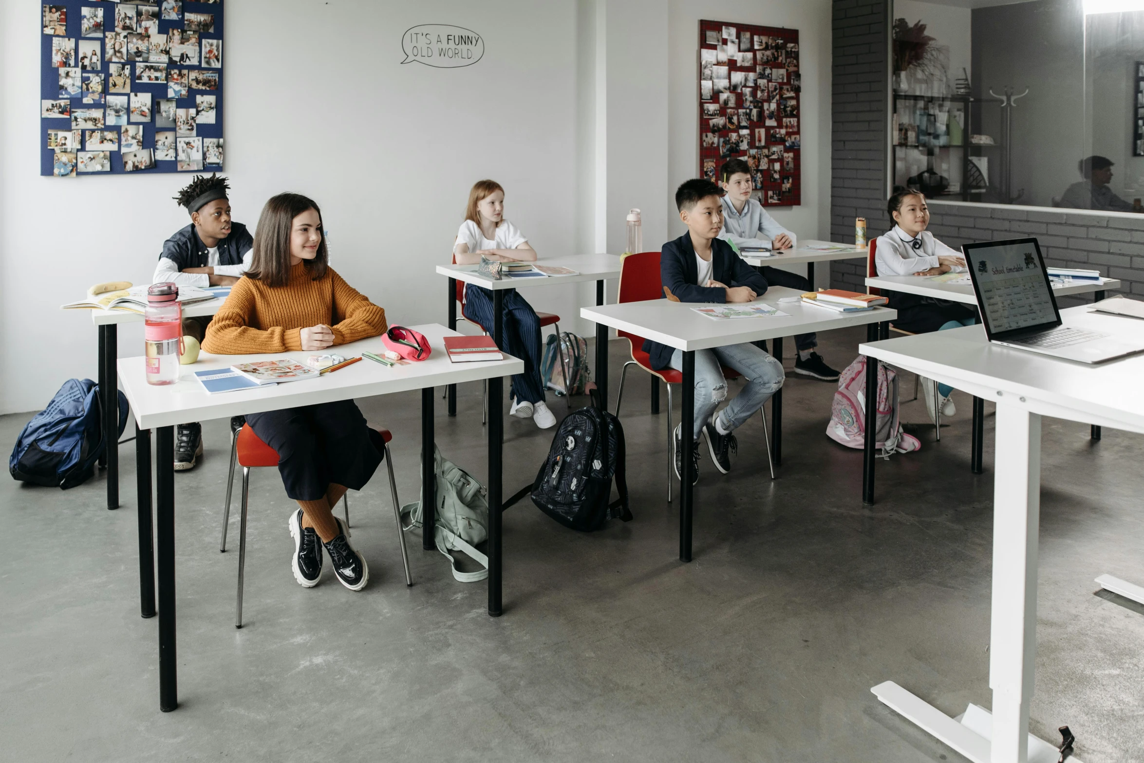 a group of people that are sitting in desks