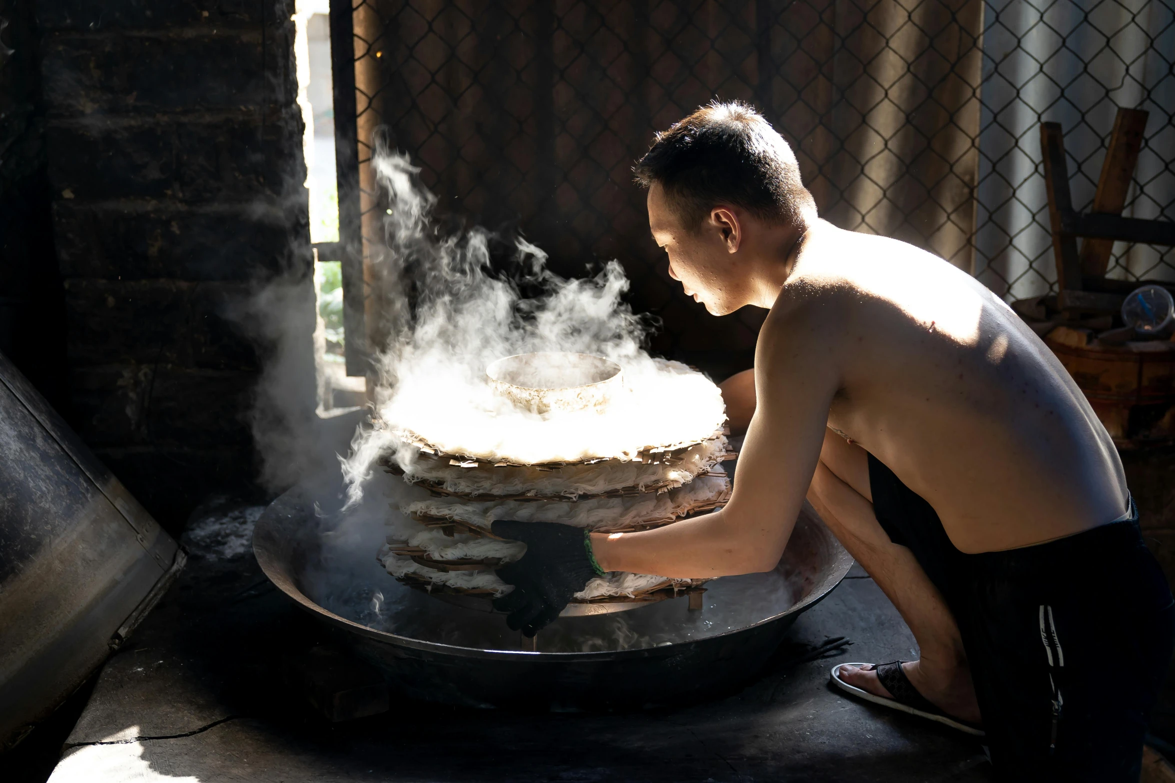 a person standing over a cake in front of some smoke